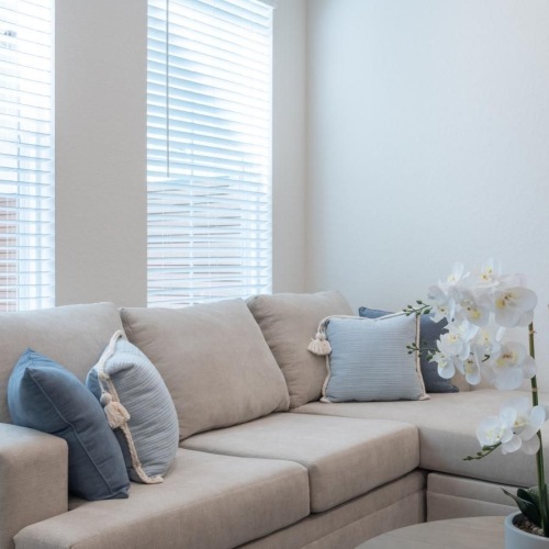 a white couch with a white pillow