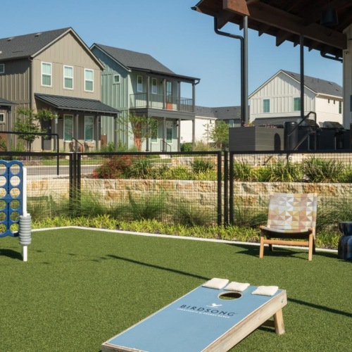 a backyard with a trampoline and chairs