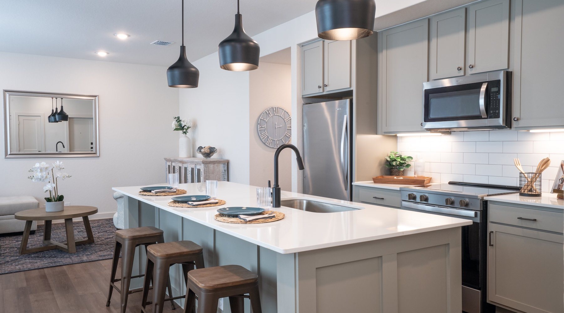 a kitchen with an island and chairs