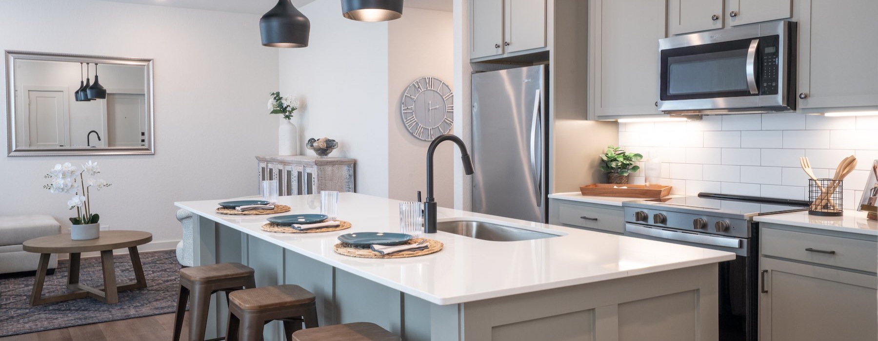 a kitchen with an island and chairs